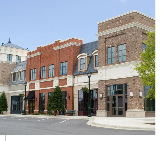 A row of brick buildings on the corner of a street.