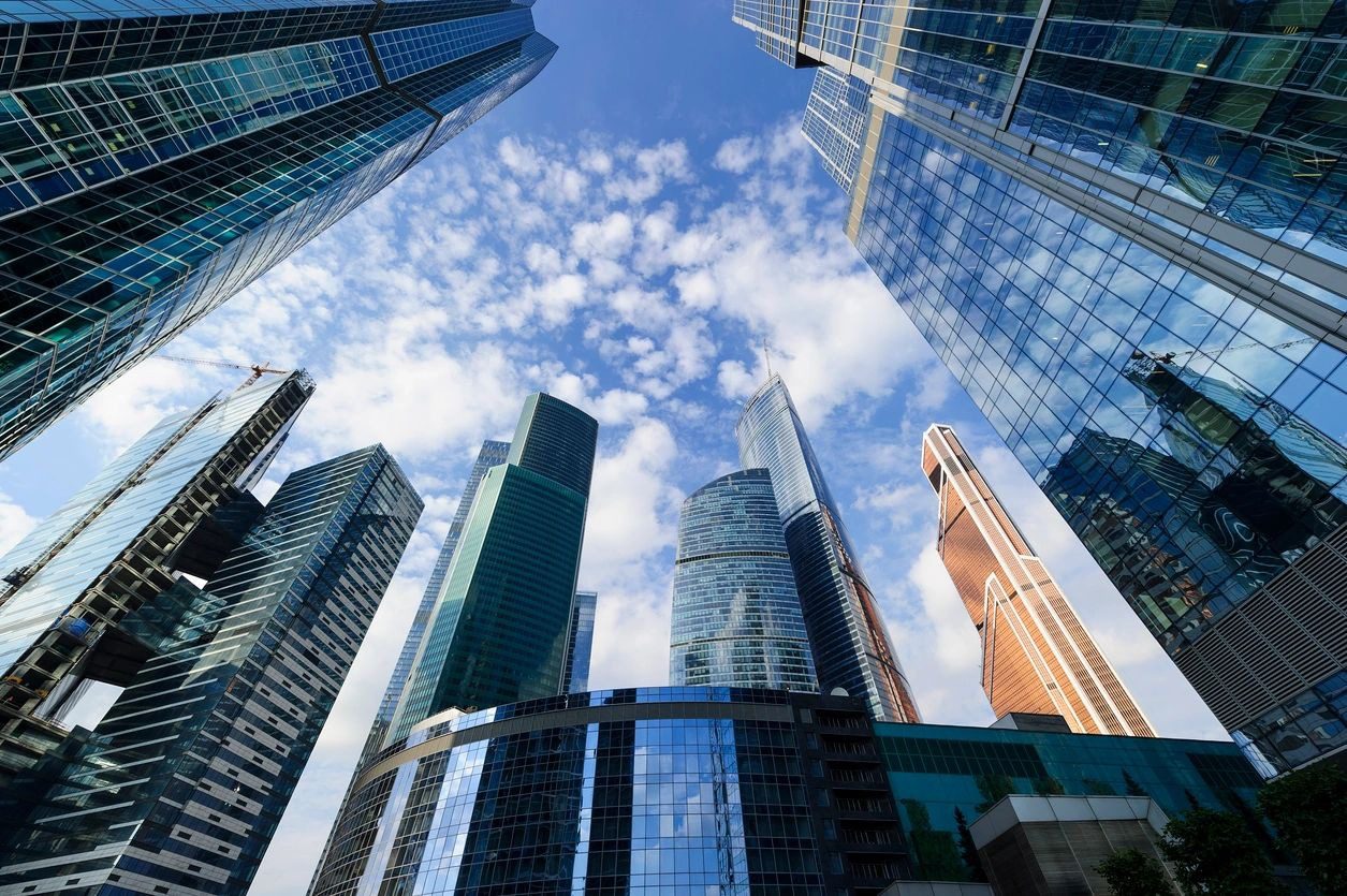 A view of some skyscrapers from below the ground.